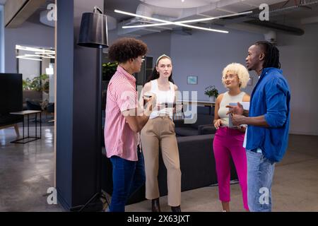 In modern office, diverse young team discussing Stock Photo