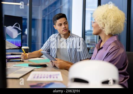 In modern office, diverse young team discussing work details Stock Photo