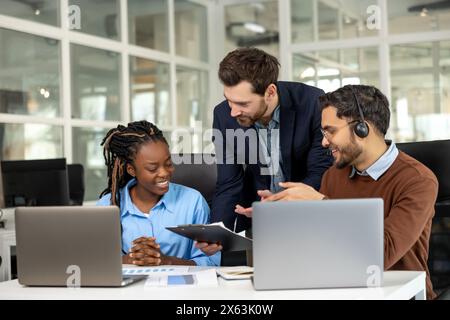 Diverse colleagues collaborating on project together Stock Photo
