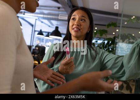 At office, diverse female business colleagues discussing with focus Stock Photo