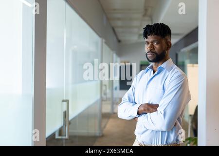 African American male manager standing with arms crossed at office, copy space Stock Photo