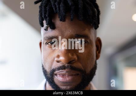 Middle-aged African American man in office, gazes seriously at camera Stock Photo