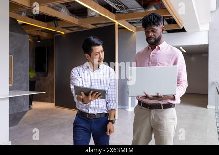 Diverse team discussing work at office in casual wear Stock Photo