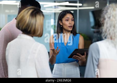 At office, Caucasian woman and African American man discussing Stock Photo
