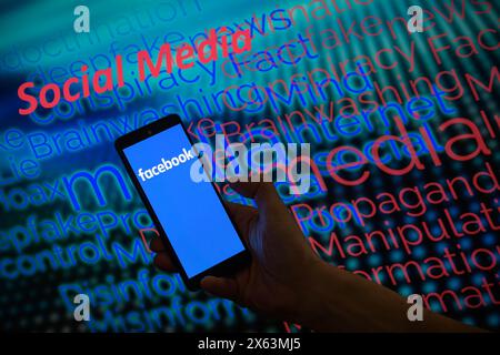 Brussels, Belgium. 12th May, 2024. Facebook is displayed on a smartphone with social media - disinformation wordle visible in the background in this photo illustration. Taken in Brussels, Belgium. On May 12, 2024. (Jonathan Raa/Sipa USA) *** Strictly for editorial news purposes only *** Credit: Sipa USA/Ģ����ý Live News Stock Photo