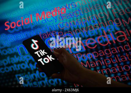 Brussels, Belgium. 12th May, 2024. The TikTok logo is displayed on a smartphone with social media - disinformation wordle visible in the background in this photo illustration.Taken in Brussels, Belgium. On May 12, 2024. (Jonathan Raa/Sipa USA) *** Strictly for editorial news purposes only *** Credit: Sipa USA/Ģ����ý Live News Stock Photo