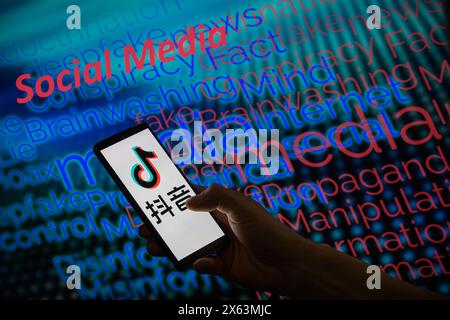 Brussels, Belgium. 12th May, 2024. The TikTok logo is displayed on a smartphone with social media - disinformation wordle visible in the background in this photo illustration.Taken in Brussels, Belgium. On May 12, 2024. (Jonathan Raa/Sipa USA) *** Strictly for editorial news purposes only *** Credit: Sipa USA/Ģ����ý Live News Stock Photo