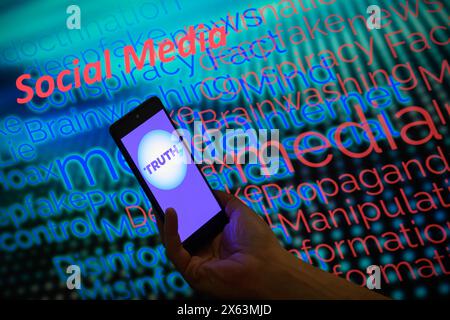 Brussels, Belgium. 12th May, 2024. The TikTok logo is displayed on a smartphone with social media - disinformation wordle visible in the background in this photo illustration.Taken in Brussels, Belgium. On May 11, 2024. (Jonathan Raa/Sipa USA) *** Strictly for editorial news purposes only *** Credit: Sipa USA/Ģ����ý Live News Stock Photo