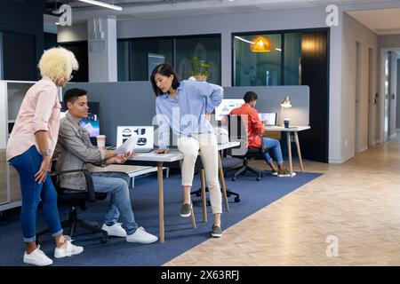 In modern office, diverse young team discussing work Stock Photo