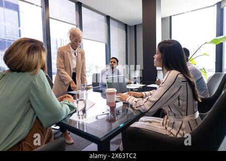 A diverse team discussing business papers in office Stock Photo