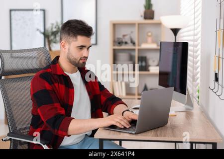 Young programmer working with laptop in office Stock Photo