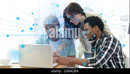 Image of security padlock icon against diverse colleagues discussing over a laptop at office Stock Photo