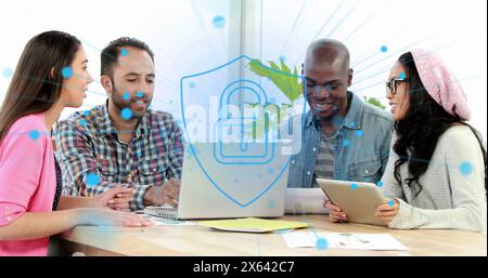 Image of security padlock icon against diverse colleagues discussing over a laptop at office Stock Photo