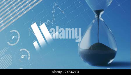 Image of statistics and financial data processing over hourglass Stock Photo
