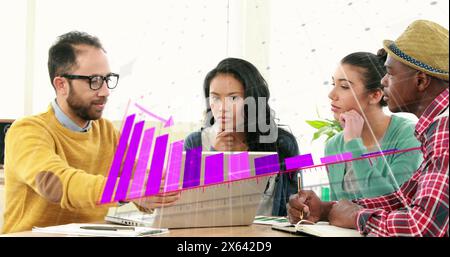 Image of statistical data processing over diverse colleagues discussing over a laptop at office Stock Photo