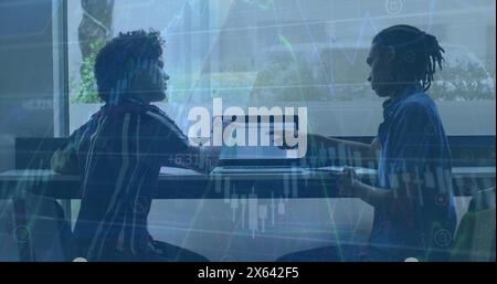 Image of financial data processing against two diverse man discussing over a laptop at office Stock Photo