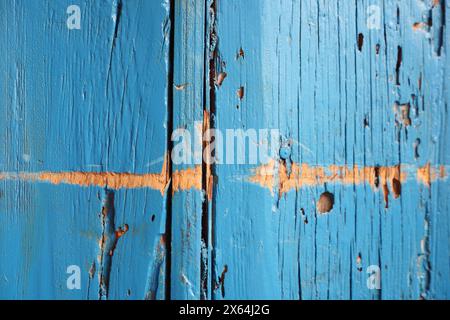 Close up of an electric blue wooden door with peeling paint Stock Photo