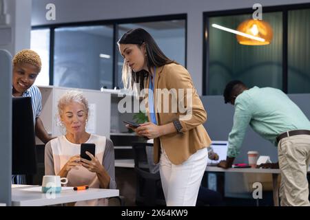 Diverse team collaborating at office, sharing ideas Stock Photo