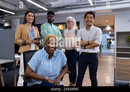 Diverse team of professionals posing together in office Stock Photo