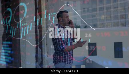 Image of graphs, loading circles, trading board over caucasian man talking on smartphone Stock Photo