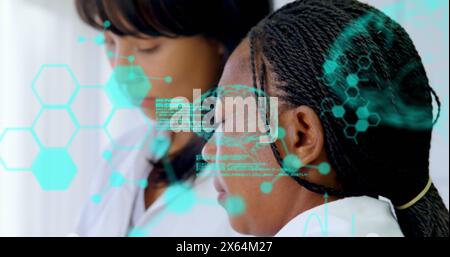 Image of medical data processing over two diverse female scientists working at laboratory Stock Photo