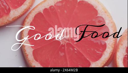 Image of good food text over sliced grapefruits on white background Stock Photo