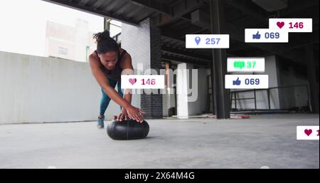 Image of multiple notification bars over african american woman doing push ups in gym Stock Photo