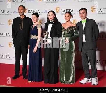 Royal Festival Hall, LONDON, ENGLAND, UK - MAY 12 2024: Paul Bazely, Louise Brealey, Kat Sadler, Lizzie Davidson and Freddie Meredith pose with the Award for Scripted Comedy for 'Such Brave Girls' in the Winners Room during the 2024 BAFTA Television Awards with P&O Cruises, London, UK. Credit: See Li/Picture Capital/Alamy Live News Stock Photo