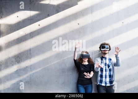 Young university students with VR headset. Virutal reality in academic settings. VR technology. Stock Photo