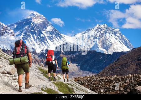 Montage of Montage of three hikers and mounts Everest and Lhotse as seen from Gokyo valley, Nepal Himalayas mountains, Nepal Himalayas mountains Stock Photo
