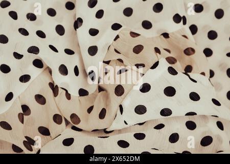 Polka dot fabric background. Beige dotted textile pattern. Fold chiffon fabric. Fold satin background. Silk fabric background. Elegant decoration. Stock Photo