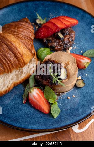 Freshly Baked Croissant with Liver Pate, Tasty Gourmet Appetizer on Table Stock Photo
