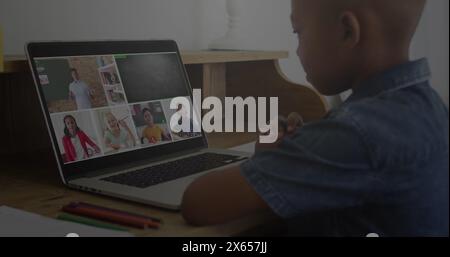 Image of graphs and binary code over african american boy having online lessons on laptop Stock Photo
