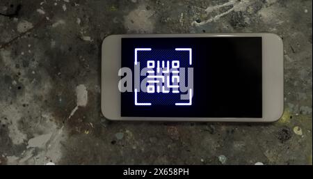 Image of gr code over smartphone lying on grey surface Stock Photo