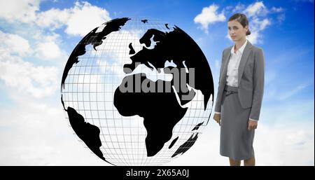 Caucasian colleague wearing formal gray suit, standing next to a large globe Stock Photo