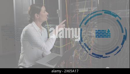 Image of firewall in loading circles, caucasian female engineer checking server using laptop Stock Photo
