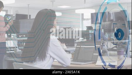 Image of eye over caucasian woman learning coding by watching online classes on laptop Stock Photo