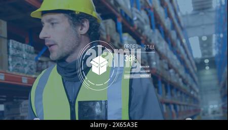 Caucasian male worker wearing yellow hard hat, checking orders Stock Photo
