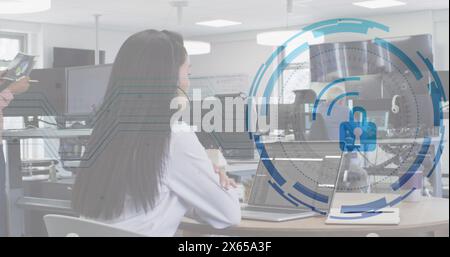 Image of padlock over caucasian woman learning coding by watching online classes on laptop Stock Photo