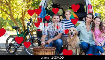 Caucasian family enjoying picnic, father sitting with son and daughter Stock Photo