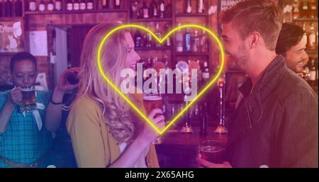 Image of neon yellow heart flickering over caucasian couple having beer in bar Stock Photo