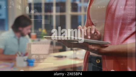 Diverse couple holding tablet, working together Stock Photo