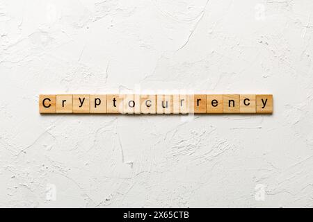 Cryptocurrency word written on wood block. Cryptocurrency text on cement table for your desing, concept. Stock Photo