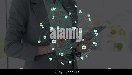Image of network of connections over businesswomen using tablet Stock Photo