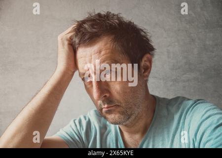 Portrait of solemn pensive mature adult caucasian man, selective focus Stock Photo