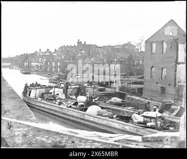 Richmond, Va. Barges with African Americans on the Canal; ruined buildings beyond, Civil War Photographs 1861-1865 Stock Photo