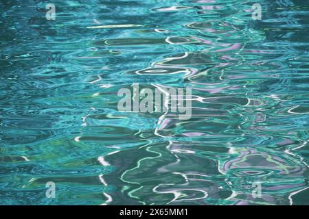 Pop art surreal gradient turquoise blue colored water surface in the sunlight Stock Photo
