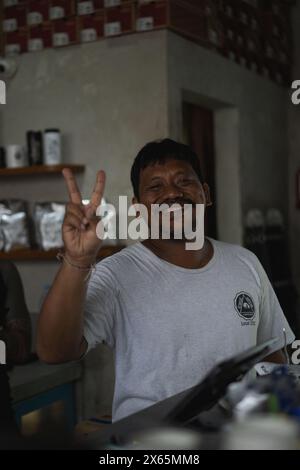Cheerful smiling Indonesian man showing the peace Stock Photo