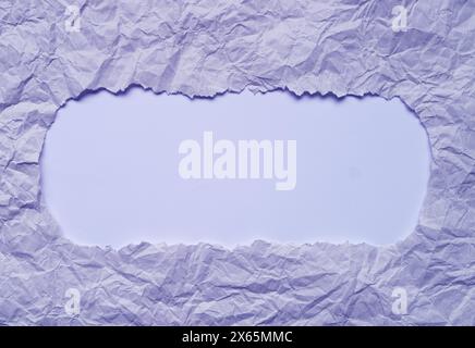 Frame of Ripped Pale Lilac Paper with Light Blue Copy Space Stock Photo