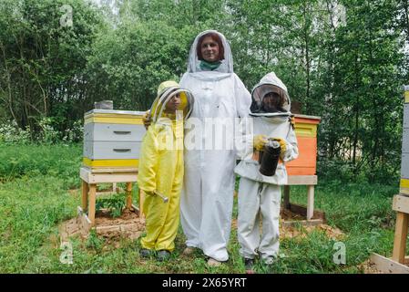 beekeepers in the garden in sunny weather takes care of the hives Stock Photo